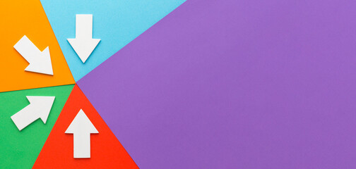 White arrows pointing inward on a colorful geometric background, copy space