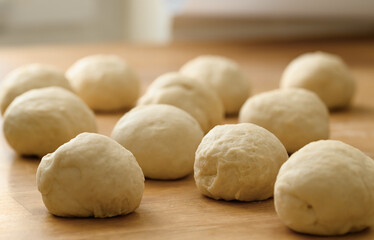 Raw yeast dough, round flour dough balls growing in the kitchen