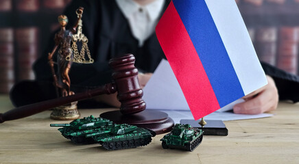 Obraz premium The scales of justice and military tanks represent conflict and law in Russia during a court hearing