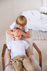 Boy children have fun covering their eyes with their hands