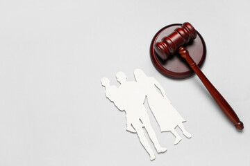 Judge's gavel with family figure on light background