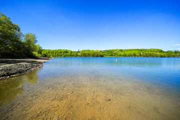 View of the Lingese Dam and the surrounding landscape near Marienheide. Nature by the lake in the Oberbergischer Kreis district.
