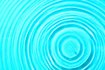 Clean water with drops on blue background, closeup