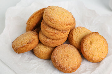 Baking paper with sweet cookies on white background, closeup