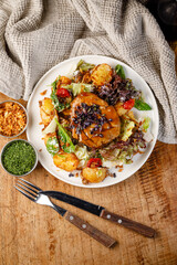 Delicious salad with potatoes and meat served at a dinner table