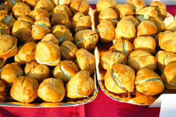 Profiteroles stuffed with cream cheese and herbs. Represents gourmet appetizer selection, savory pastry creativity, elegant party catering, contemporary hors d’oeuvres styling, and modern finger food.
