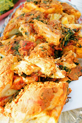 Pie filled with paprika, onion, tomato, and herb, cut into portions. Illustrates savory comfort baking, vegetarian food, family-style sharing dishes, homestyle cooking, and plant-forward cuisine.