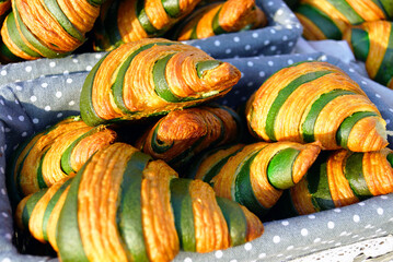 Crispy savory croissants with a green stripe. Symbolizes modern bakery design, continental breakfast, experimental pastry decoration, culinary innovation, vegan treats, and handcrafted gourmet food.