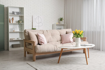 Interior of light living room with sofa and table