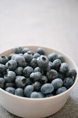 Plate full of fresh ripe blueberry closeup. Sweet berries as healthy dessert. Summer fruits on the table. Natural source of vitamins, healthy eating