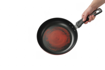 Hand holding red and black frying pan isolated on a transparent background cookware
