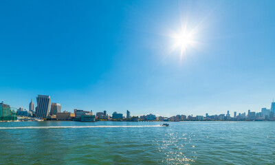 Manhattan skyline seen from Hudson river under a shining morning sun
