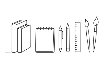 Stationery items arranged on a table featuring books, a notepad, a pen, a ruler, and paintbrushes for creative work