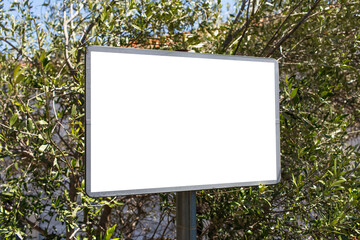 Close-up of small billboard with empty mockup in the woods.