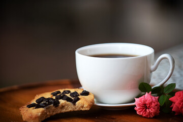 White cup black coffee cookie chocolate wooden tray pink rose morning light cozy warm beverage