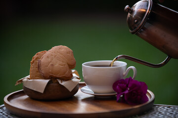 Warm coffee white cup metal kettle pour wooden tray cookie biscuit basket purple flower outdoor