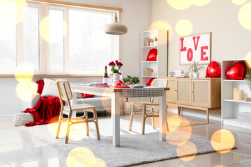 Interior of light living room with served table for Valentine's Day celebration