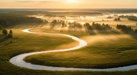 River meandering through a misty landscape at sunrise with sunbeams, nature photography.
