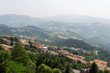 Top view from the hill of beautiful San Marino city buildings and fields.
