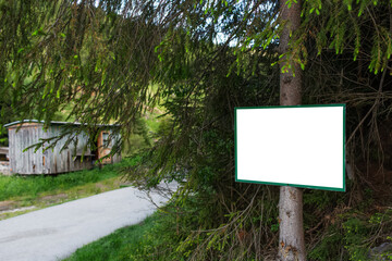 Close-up of small billboard with empty mockup in the woods. © Lalandrew