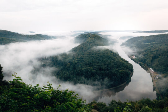 Scenic Aerial View of Saarschleife River Bend in Morning Mist, Famous German Landscape with Foggy Valley