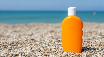 Orange sunscreen bottle on pebble beach with sea isolated on sunny day