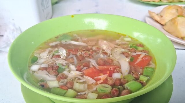 a hot dish called soto ayam, a typical Indonesian dish that gives off steam