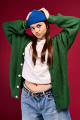 Trendy teenage girl showcases winter style with vibrant colors in a studio setting
