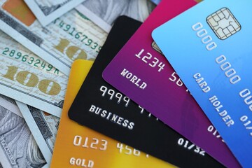 One hundred US dollar bill banknotes and credit cards for banking and payments. Concept of business and bank service