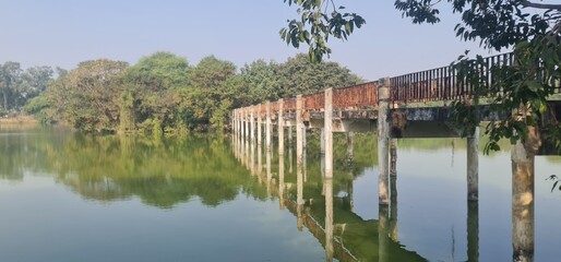 Abandoned Bridge with Reflection in Lake