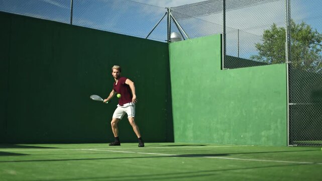 Professional padel tennis player hitting a forehand shot