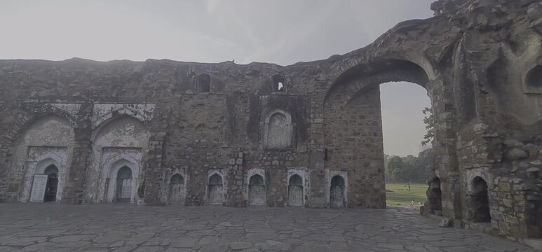 Medieval Stone Archways and Weathered Rubble Walls of the 14th-Century Jami Masjid Ruins within the Feroz Shah Kotla Fort Complex in New Delhi India