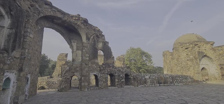 Medieval Stone Archways and Weathered Rubble Walls of the 14th-Century Jami Masjid Ruins within the Feroz Shah Kotla Fort Complex in New Delhi India