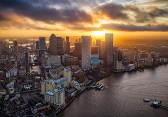 Aerial view of the Docklands and financial hub Canary Wharf in London, England, during a colorful winter sunrise