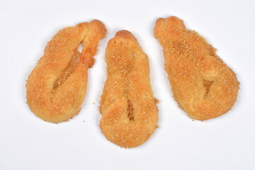 Three twisted, light brown cookies sprinkled with coarse sugar are placed on a clean white background