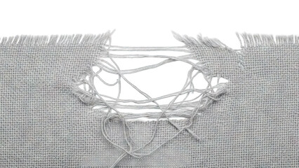 Torn gray fabric with a large hole revealing white background.