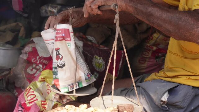 vendor selling groundnuts (peanuts) at a market in India