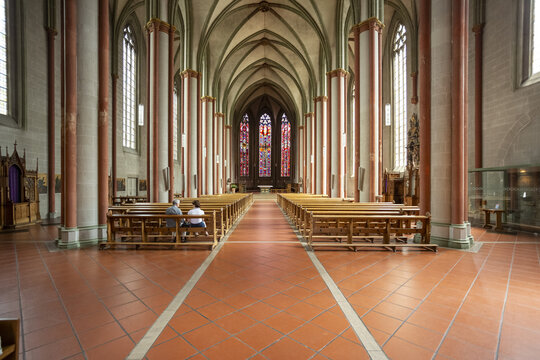 View of grand arches rise above rows of wooden pews, at St paulus dom Cathedral, Muenster, North Rhine-Westphalia, Germany.