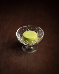 green matcha pudding in crystal dessert cup on wood table