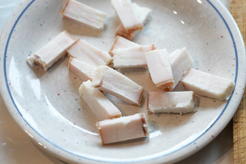 Cubed lardo resting on a speckled plate, ready to inspire culinary creations