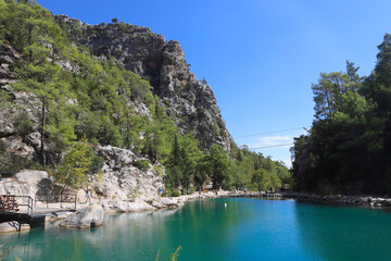 Small pond in the mountains with turquoise water in Goynuk canyon,  Turkey. Emerald lake in the forest surround mountains.