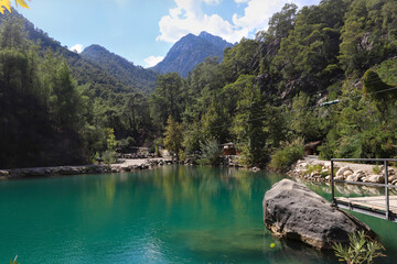 Small pond in the mountains with turquoise water in Goynuk canyon,  Turkey. Emerald lake in the forest surround mountains.