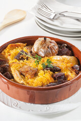 Traditional baked rice with cured meats, sausages, and meat