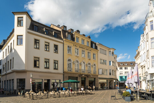 View of historic buildings in the old city bask in the warm glow of the afternoon sun, casting long shadows across the cobblestone streets, Bonn, North Rhine-Westphalia, Germany.