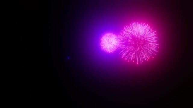 Loopable animation of glowing pink and purple fireworks bursting on black background for New Year celebration and party overlay