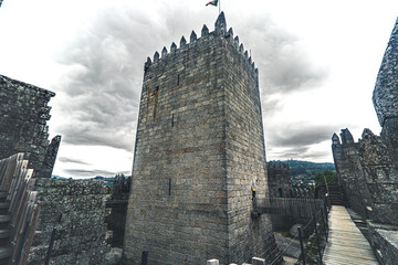 Main Tower of Guimaraes Castle with Portuguese Flag