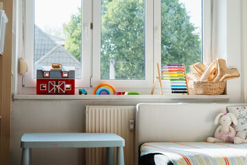 Tidy children room. Interior decor of clean children's room. Organizing storage in kids room: bookshelves and educational and soft toys. Montessori education. A childs bedroom with toys and books.