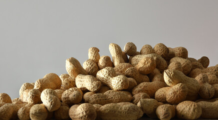Pile of peanuts in shell isolated on a gray background