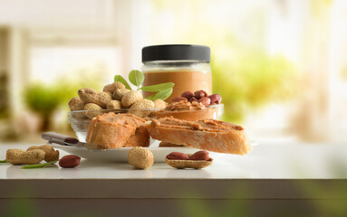 Slices of bread with peanut butter on bench in kitchen