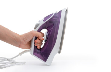 hand holding purple electric iron placed on isolated white background